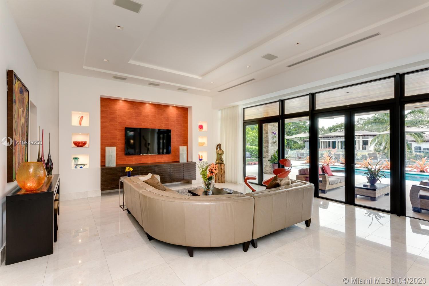 810 Jeronimo Drive Coral Gables, FL 33146 - Photo 19 of 32 a living room with furniture and a flat screen tv