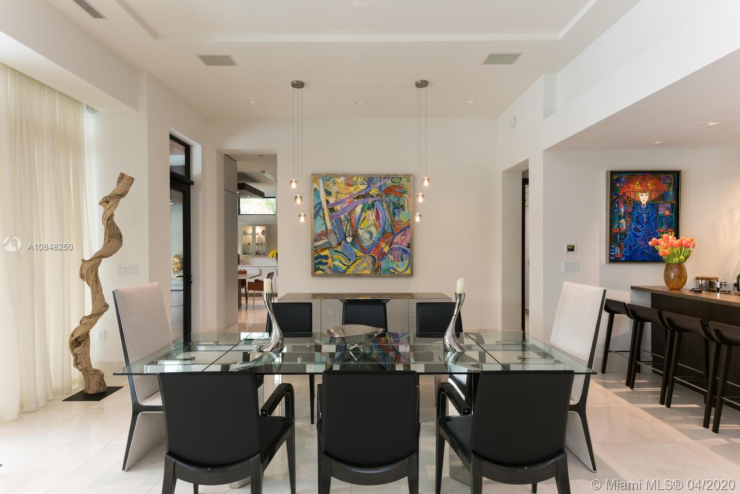 810 Jeronimo Drive Coral Gables, FL 33146 - Photo 20 of 32 a view of a dining room with furniture window and wooden floor