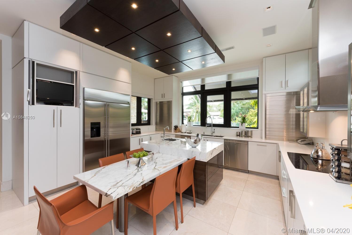810 Jeronimo Drive Coral Gables, FL 33146 - Photo 22 of 32 a large kitchen with a table and chairs