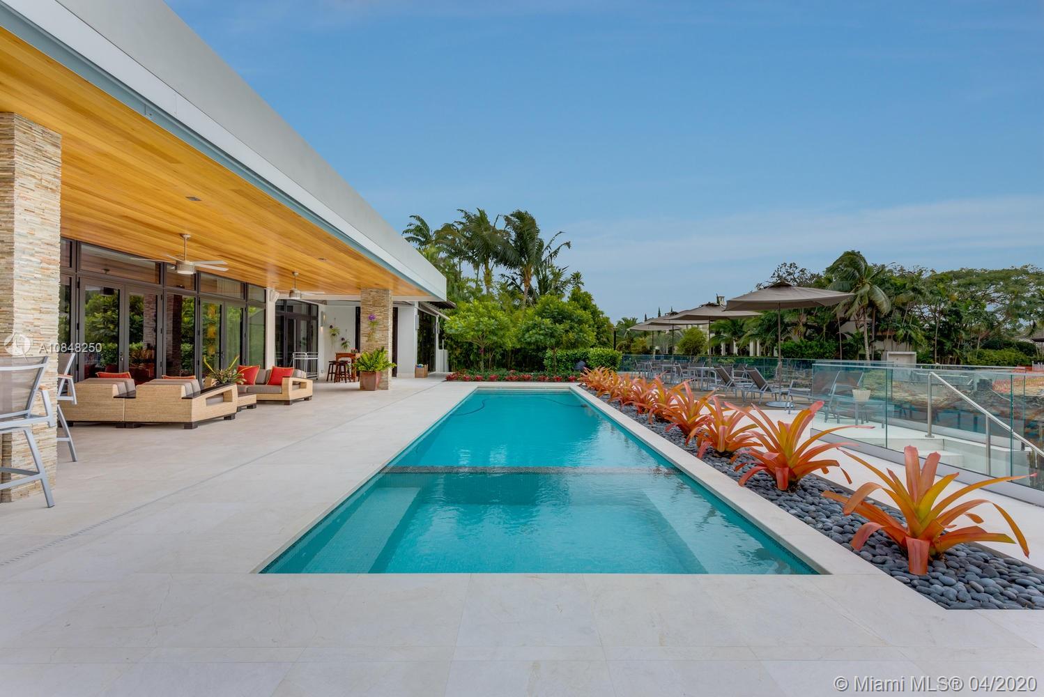 810 Jeronimo Drive Coral Gables, FL 33146 - Photo 26 of 32 a view of swimming pool with a patio and a yard