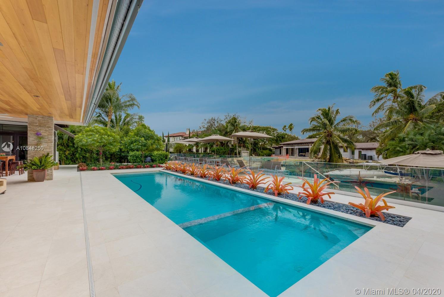 810 Jeronimo Drive Coral Gables, FL 33146 - Photo 27 of 32 a view of a swimming pool with chairs