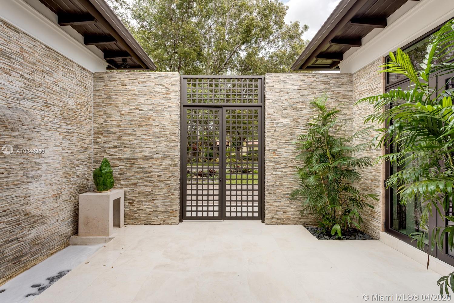 810 Jeronimo Drive Coral Gables, FL 33146 - Photo 31 of 32 a view of a door with a potted plant