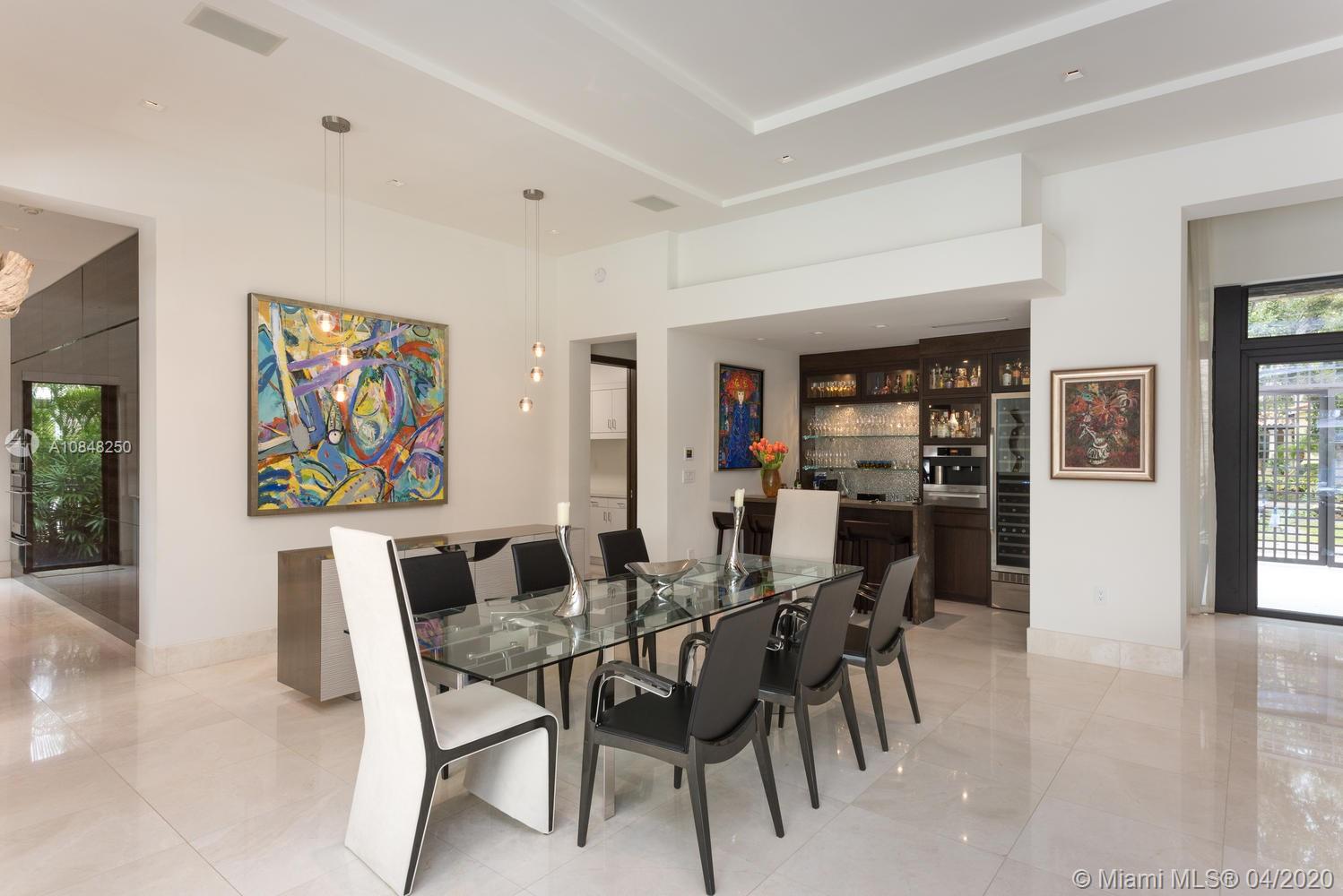 810 Jeronimo Drive Coral Gables, FL 33146 - Photo 5 of 32 a view of a dining room with furniture and wooden floor