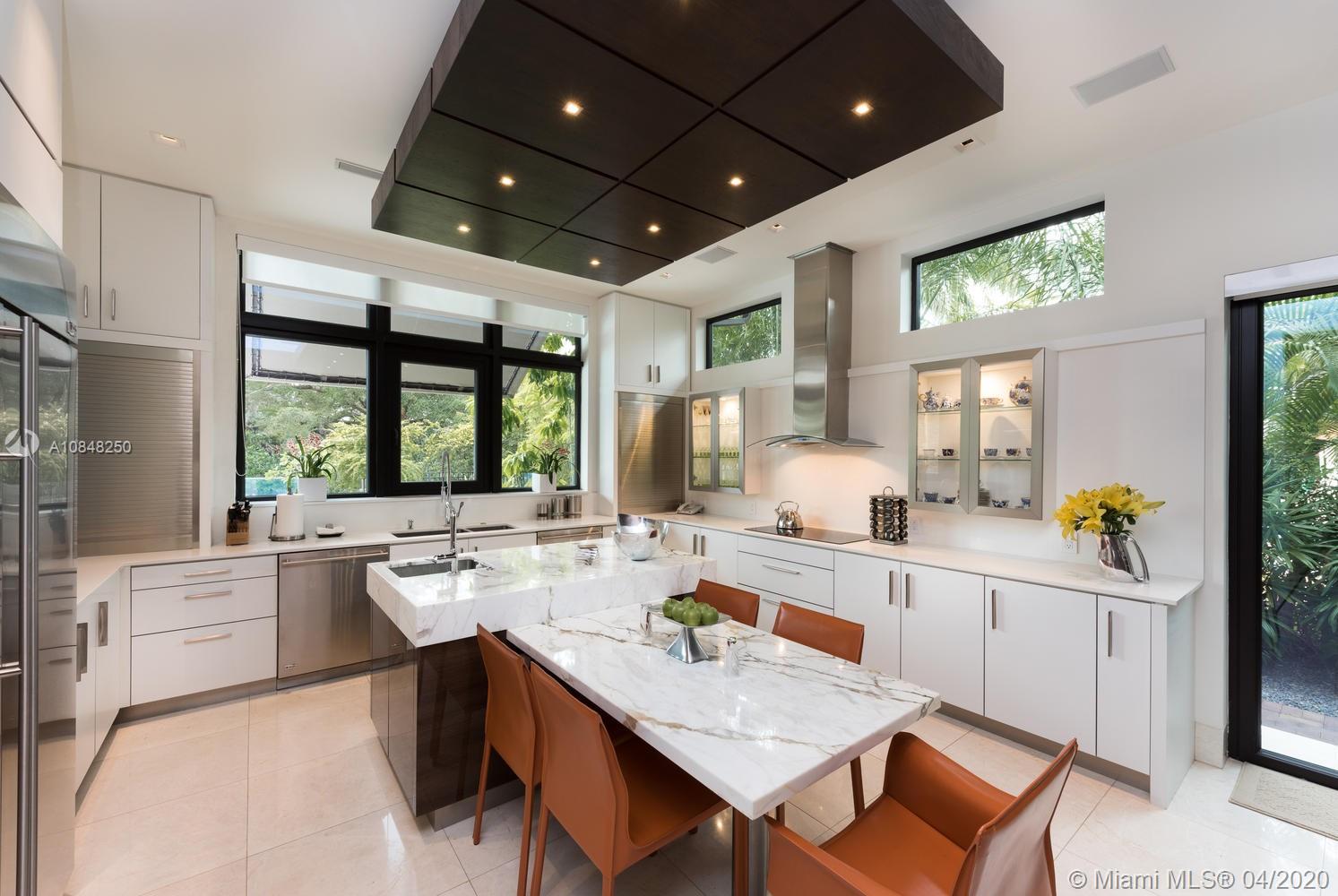 810 Jeronimo Drive Coral Gables, FL 33146 - Photo 6 of 32 a large kitchen with kitchen island a large window in it