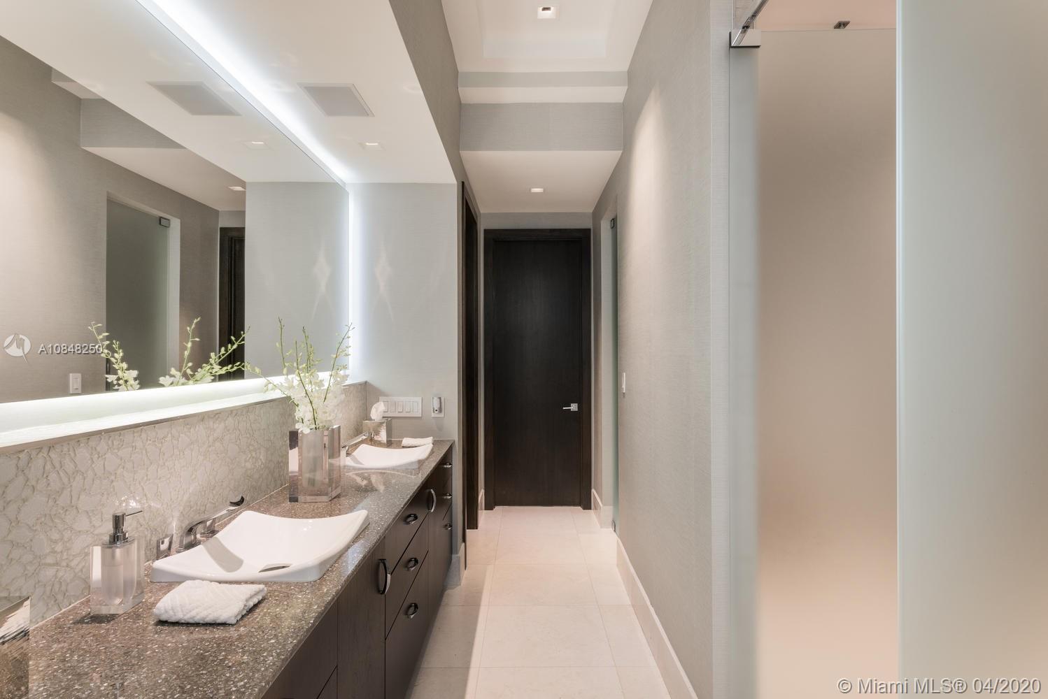 810 Jeronimo Drive Coral Gables, FL 33146 - Photo 8 of 32 a bathroom with a granite countertop sink and a mirror