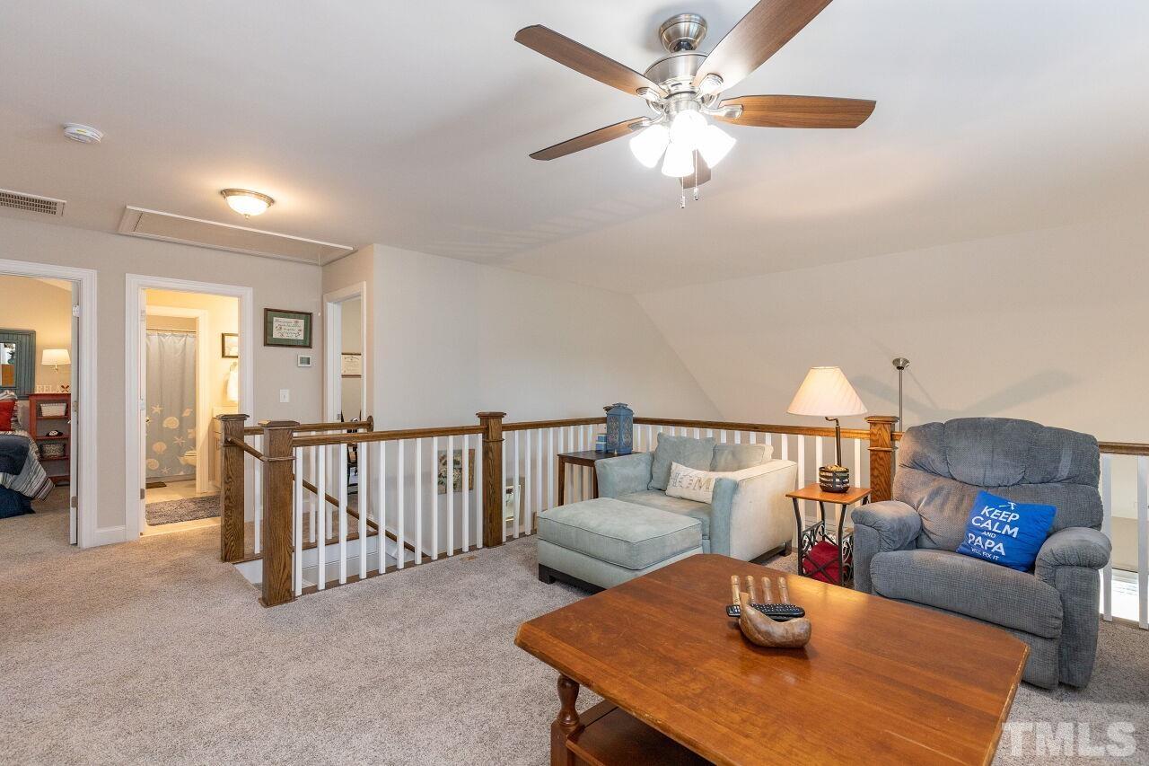 3508 Jones Lake Road Fuquay-Varina, NC 27526 - Photo 19 of 41 a living room with furniture and a chandelier