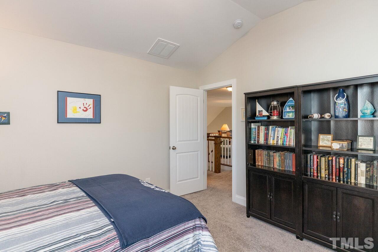 3508 Jones Lake Road Fuquay-Varina, NC 27526 - Photo 21 of 41 a bedroom with a bed and a book shelf