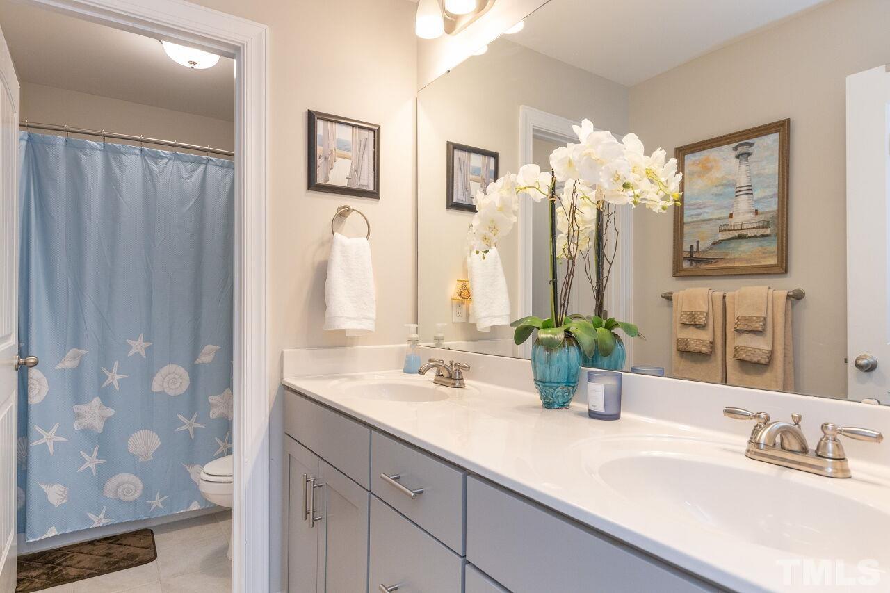 3508 Jones Lake Road Fuquay-Varina, NC 27526 - Photo 26 of 41 a bathroom with a double vanity sink and a mirror