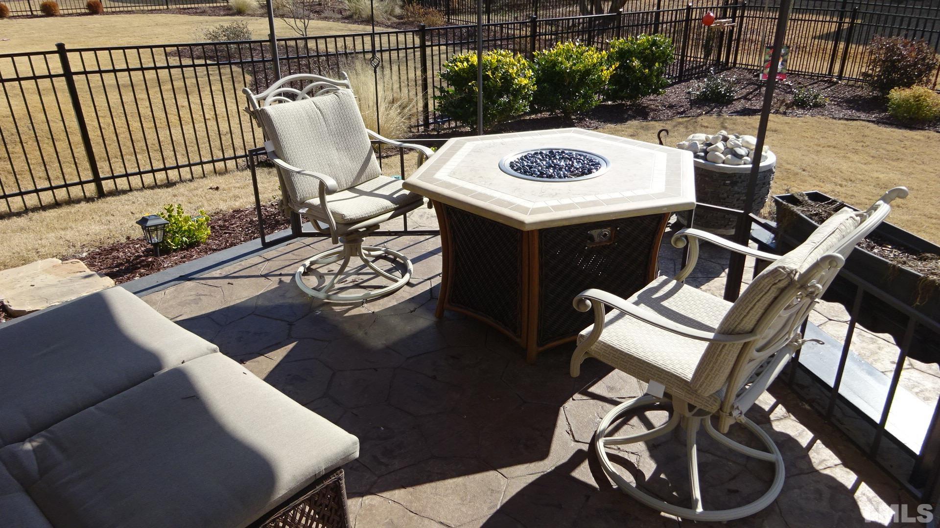 3508 Jones Lake Road Fuquay-Varina, NC 27526 - Photo 6 of 41 a view of a patio with table and chairs with wooden floor