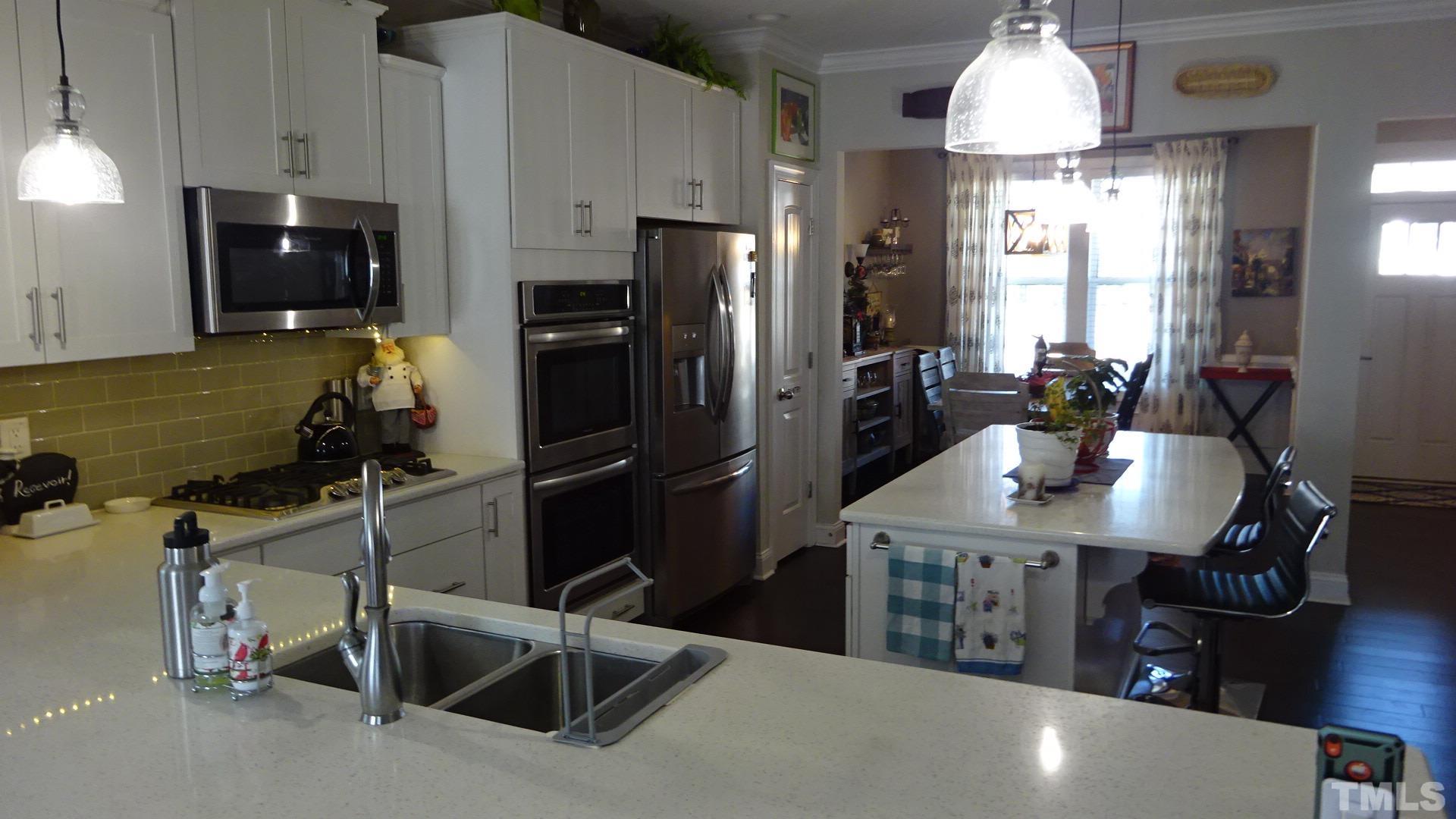3508 Jones Lake Road Fuquay-Varina, NC 27526 - Photo 8 of 41 a kitchen with refrigerator and chairs