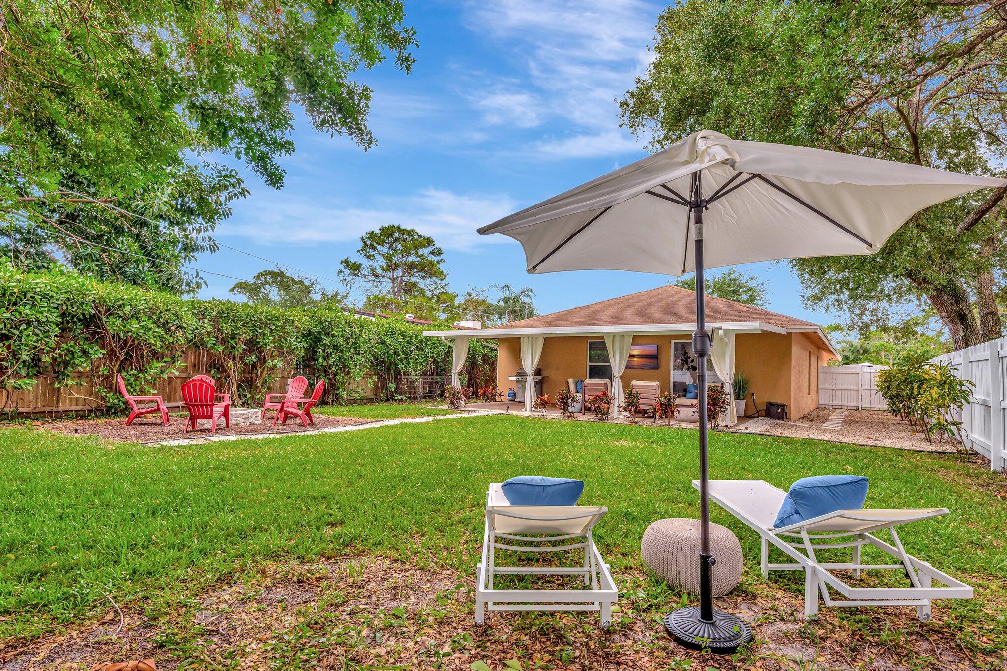4901 Lincoln Road Delray Beach, FL 33445 - Photo 37 of 56 a view of a patio with table and chairs under an umbrella