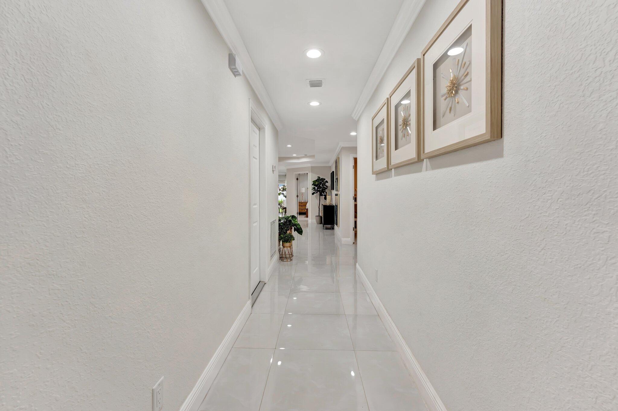 4901 Lincoln Road Delray Beach, FL 33445 - Photo 4 of 56 a view of a hallway with wooden floor and entryway