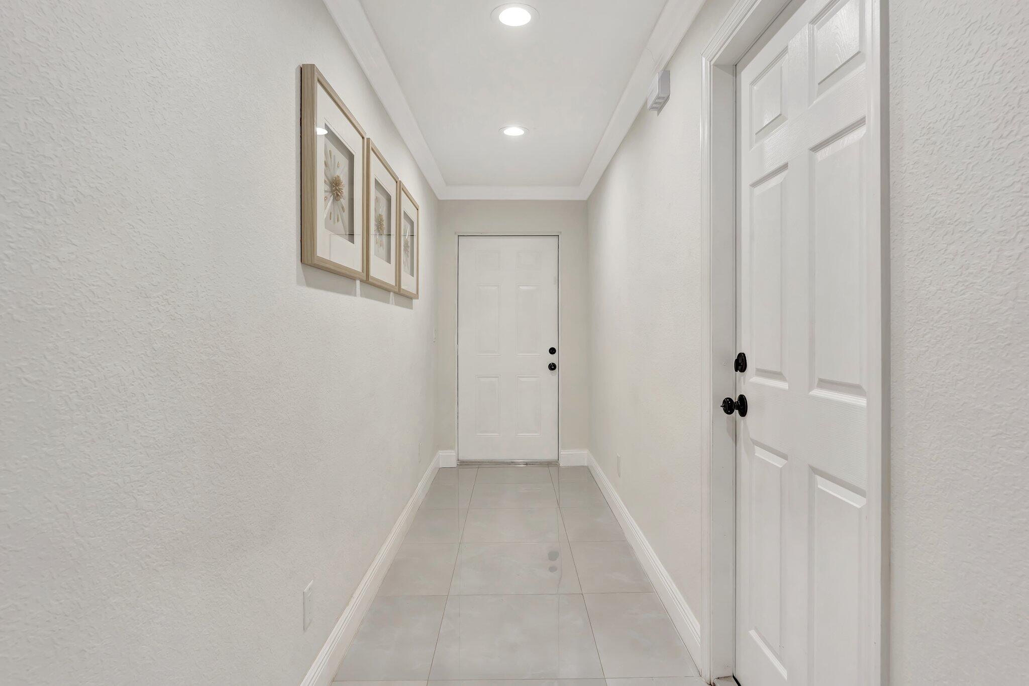 4901 Lincoln Road Delray Beach, FL 33445 - Photo 5 of 56 a view of a hallway with wooden floor and entryway