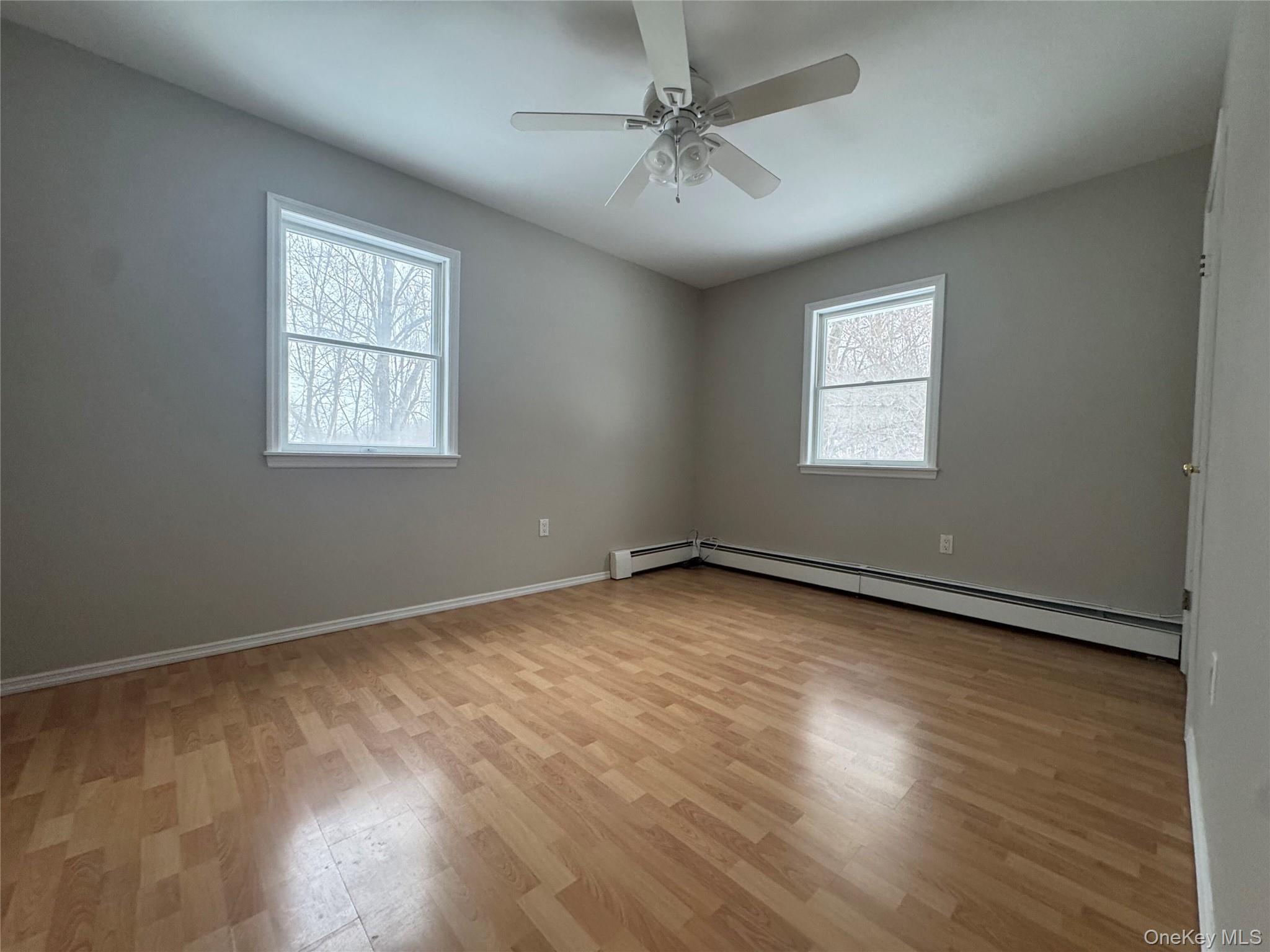 2217 Highway 300, Unit 1 Wallkill, NY 12589 - Photo 16 of 22 a view of an empty room with a window and wooden floor