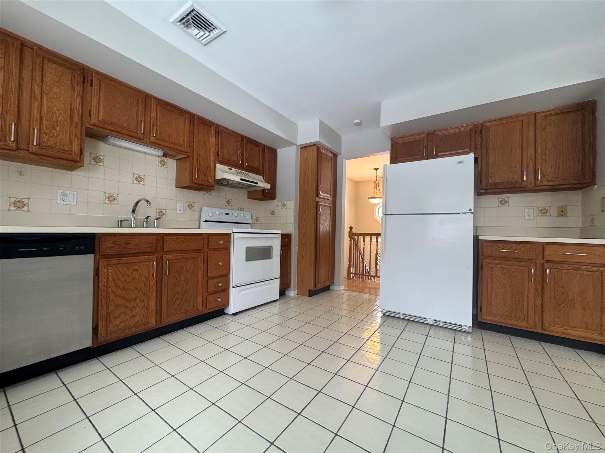 2217 Highway 300, Unit 1 Wallkill, NY 12589 - Photo 2 of 22 a kitchen with a sink a refrigerator and cabinets