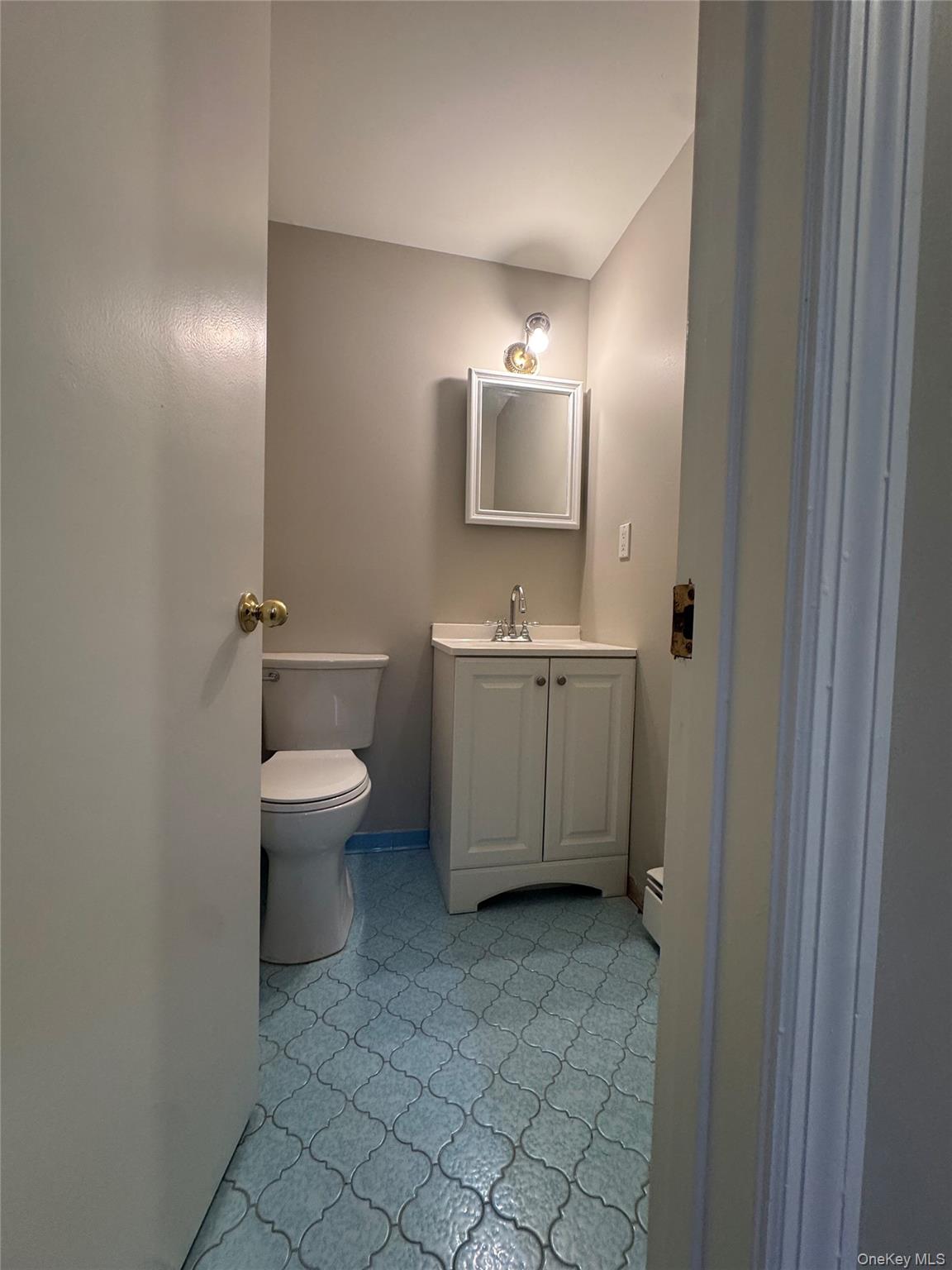 2217 Highway 300, Unit 1 Wallkill, NY 12589 - Photo 21 of 22 a bathroom with a toilet sink and mirror