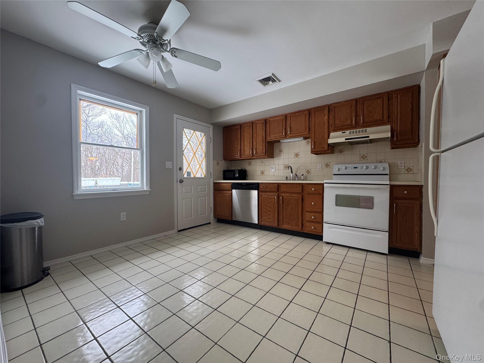 2217 Highway 300, Unit 1 Wallkill, NY 12589 - Photo 3 of 22 a kitchen with stainless steel appliances granite countertop a stove a sink and a refrigerator