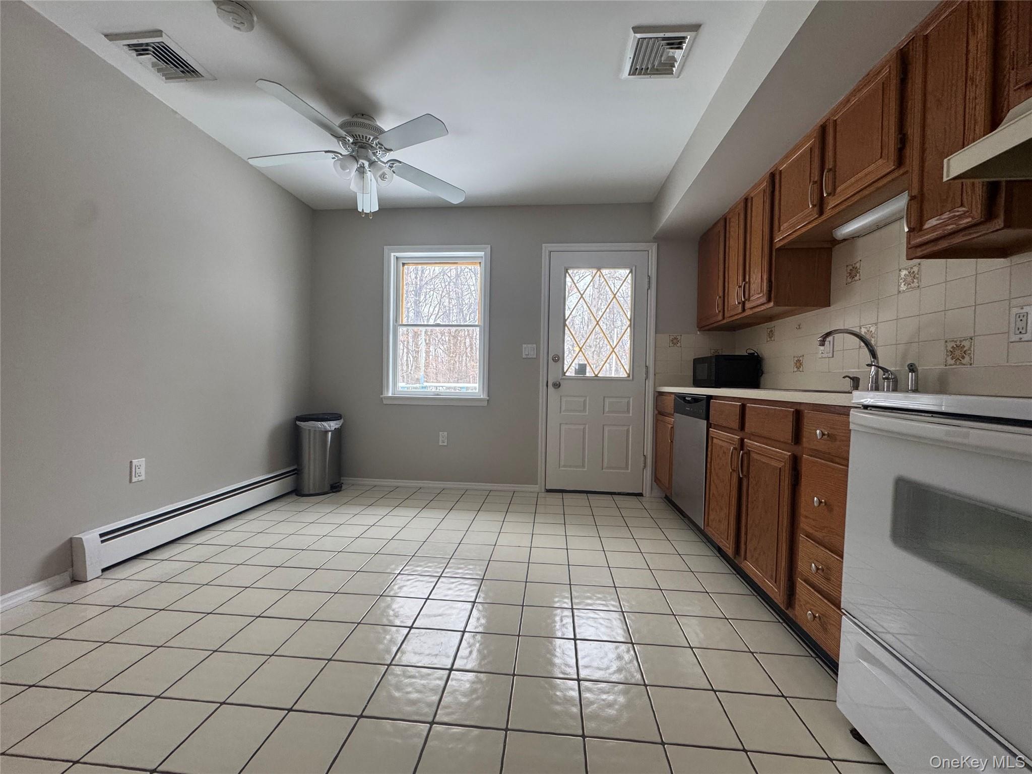 2217 Highway 300, Unit 1 Wallkill, NY 12589 - Photo 4 of 22 a kitchen with stainless steel appliances a sink cabinets and window