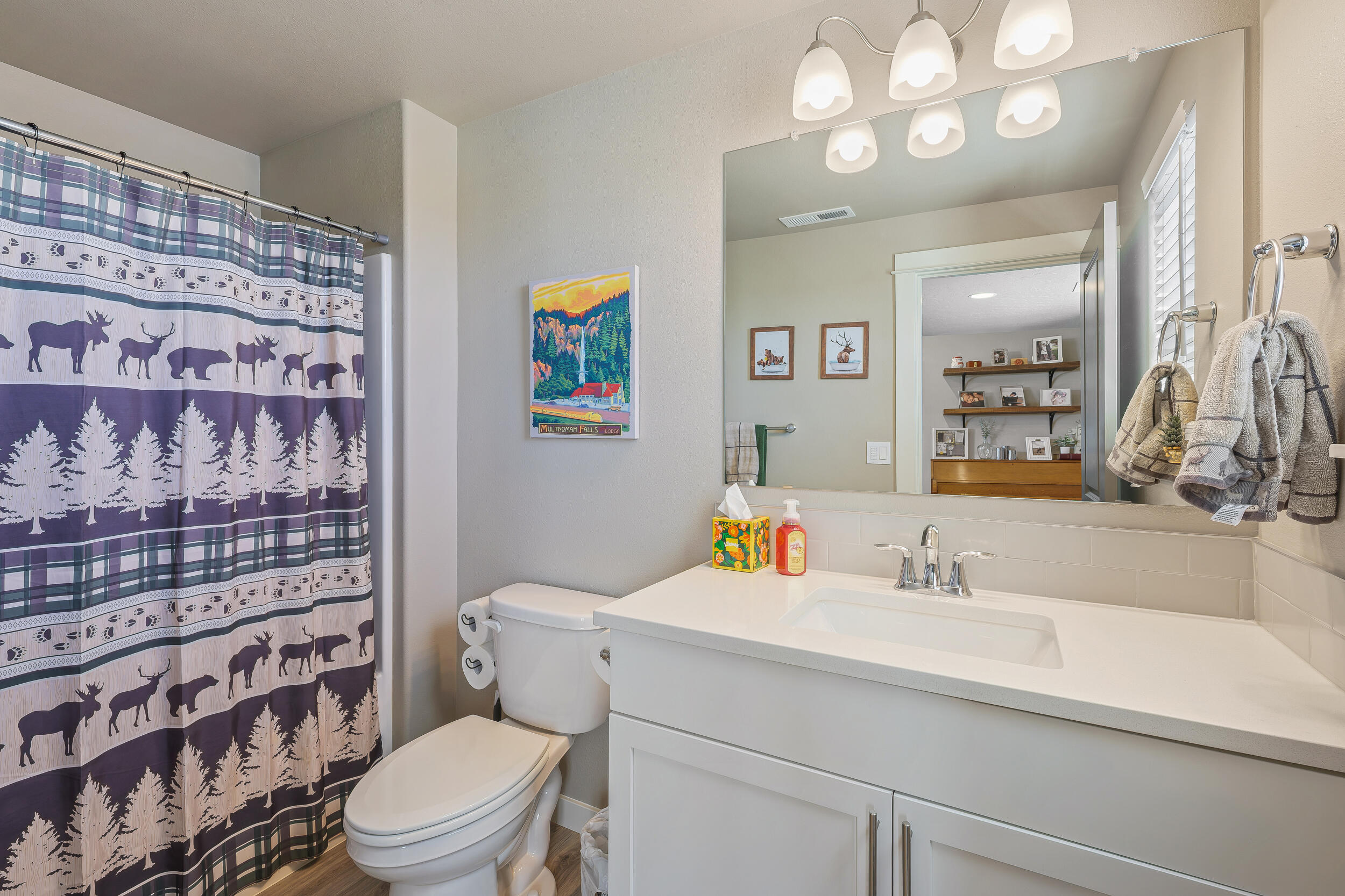 3370 Northwest 15th Street Redmond, OR 97756 - Photo 11 of 27 a bathroom with a sink a toilet and a shower curtain