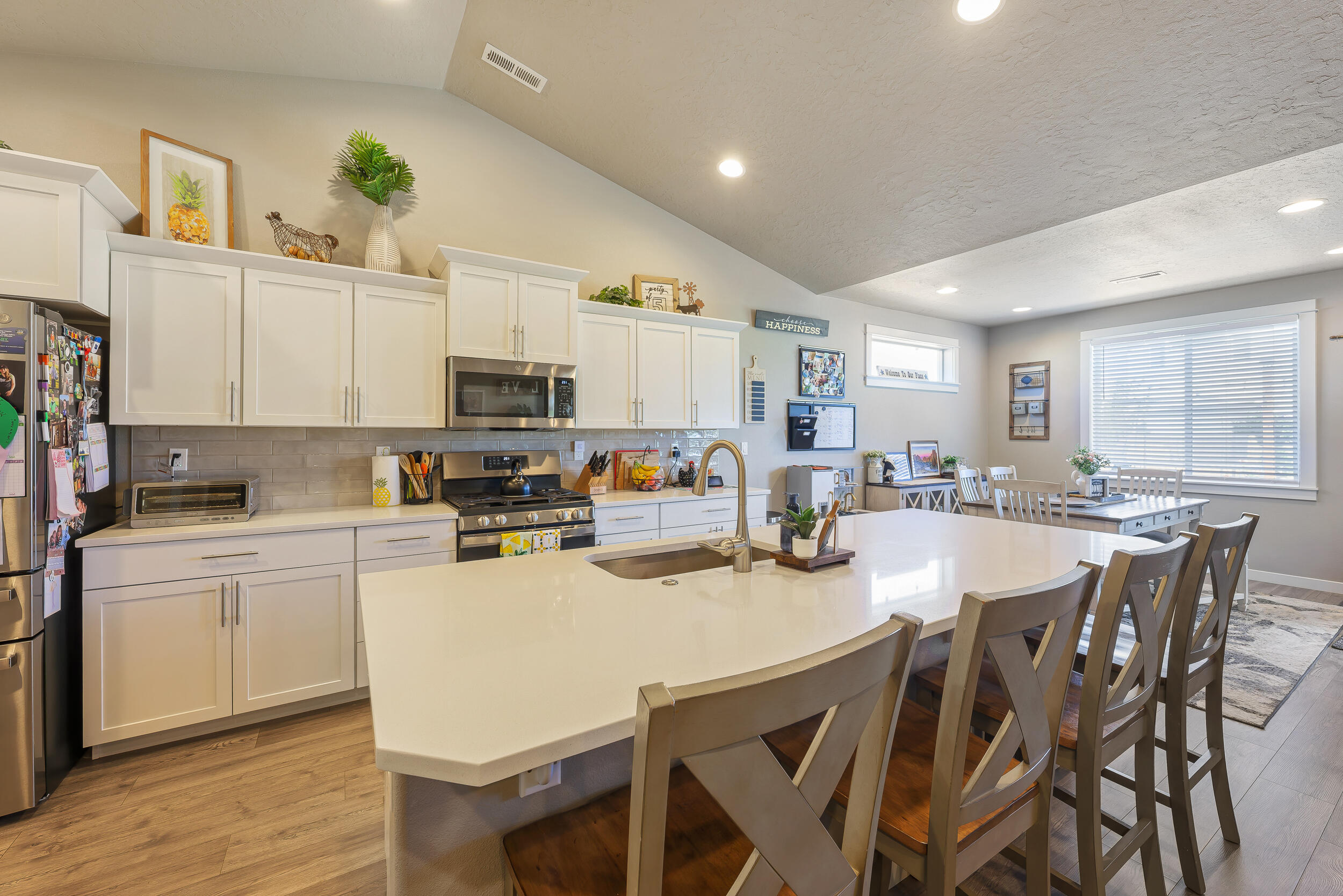 3370 Northwest 15th Street Redmond, OR 97756 - Photo 15 of 27 a kitchen with a dining table chairs and refrigerator
