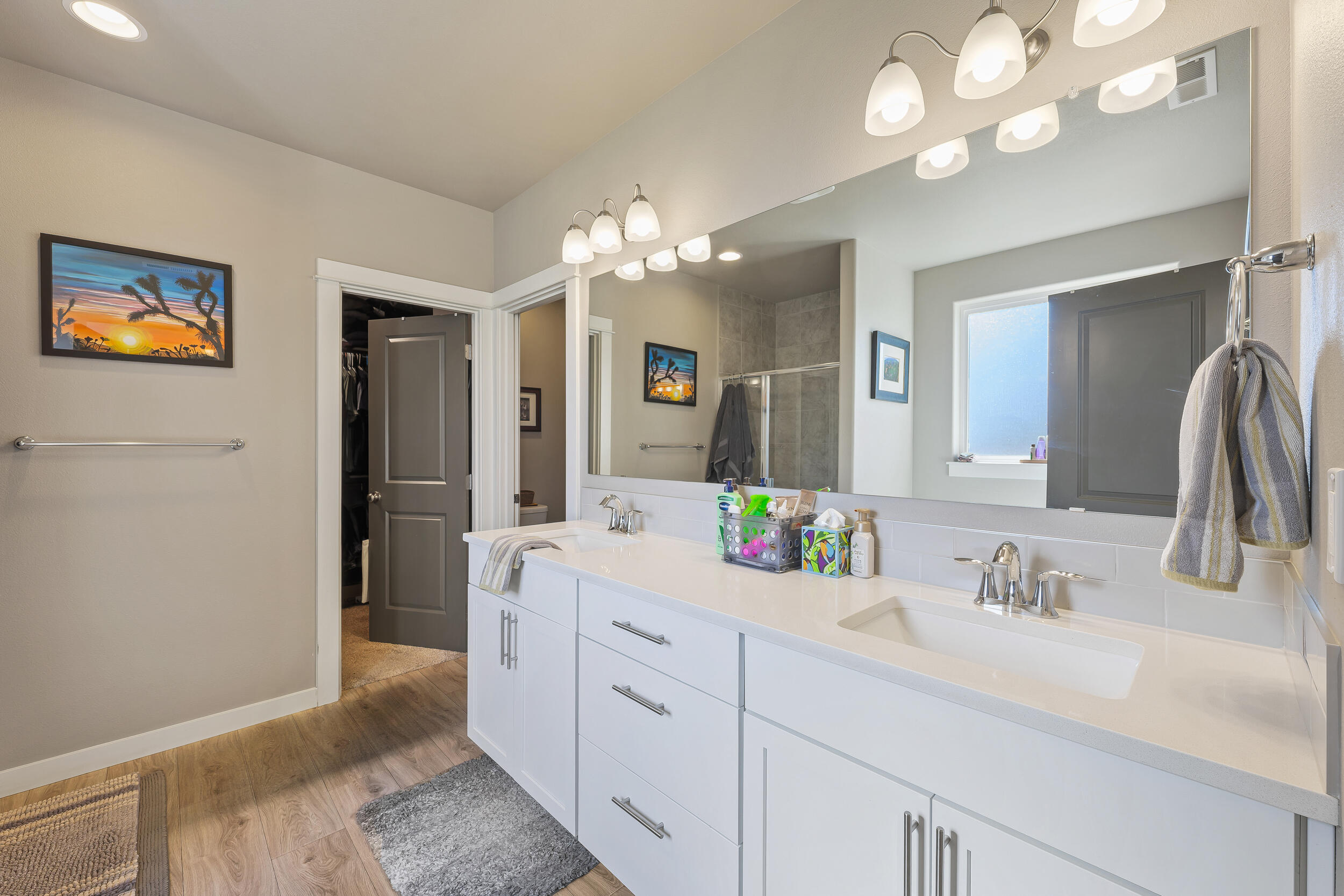 3370 Northwest 15th Street Redmond, OR 97756 - Photo 19 of 27 a spacious bathroom with a granite countertop sink a light fixture and a mirror