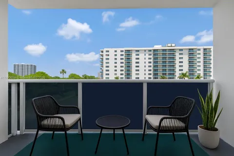 a view of a chairs and table in a balcony