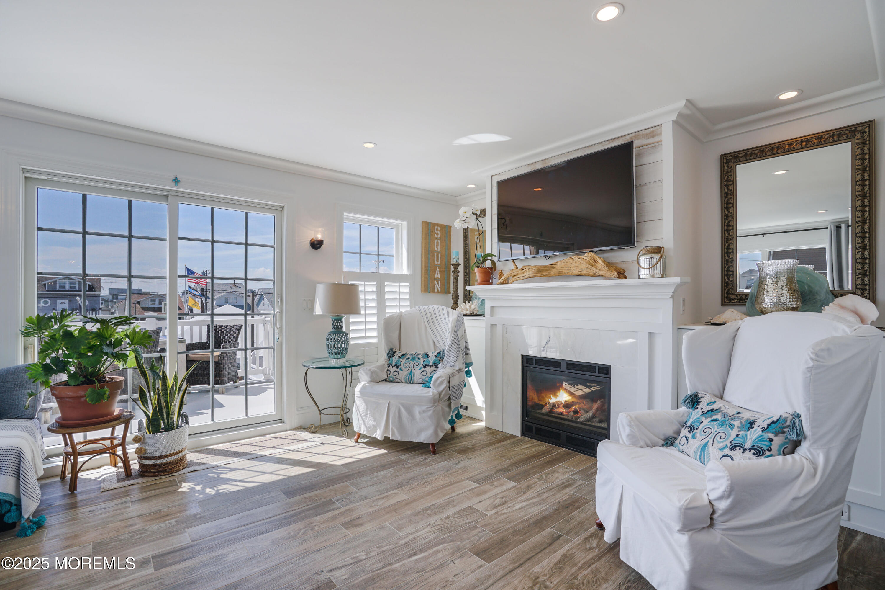 229 1st Avenue Manasquan, NJ 08736 - Photo 11 of 32 a living room with furniture a flat screen tv and a fireplace