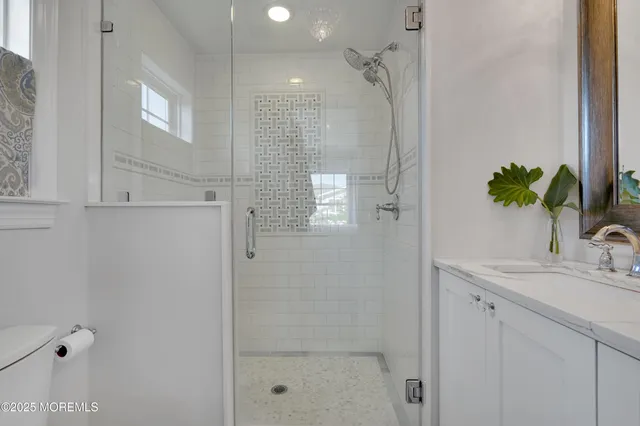 a bathroom with a shower sink and mirror