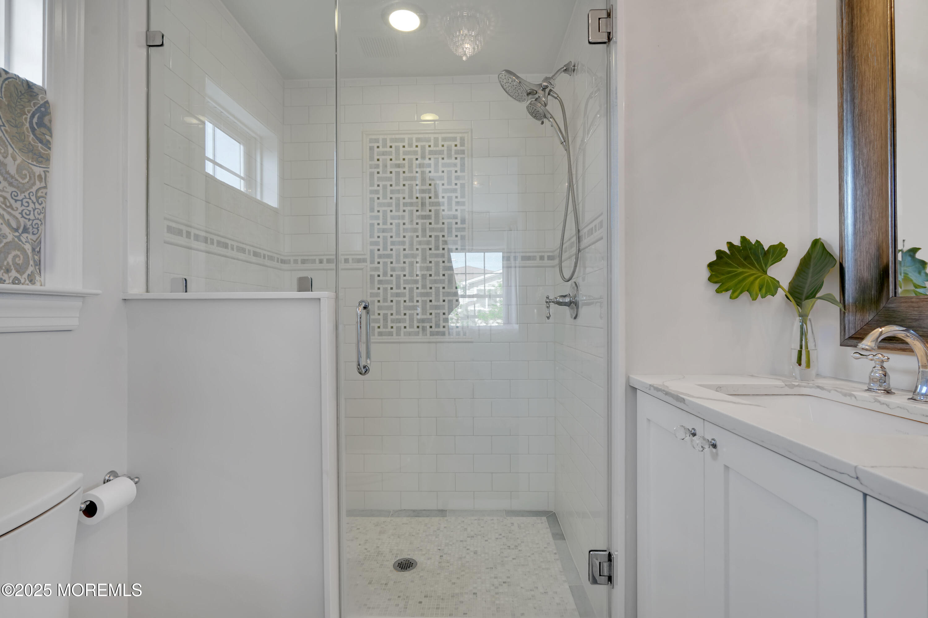 229 1st Avenue Manasquan, NJ 08736 - Photo 18 of 32 a bathroom with a shower sink and mirror