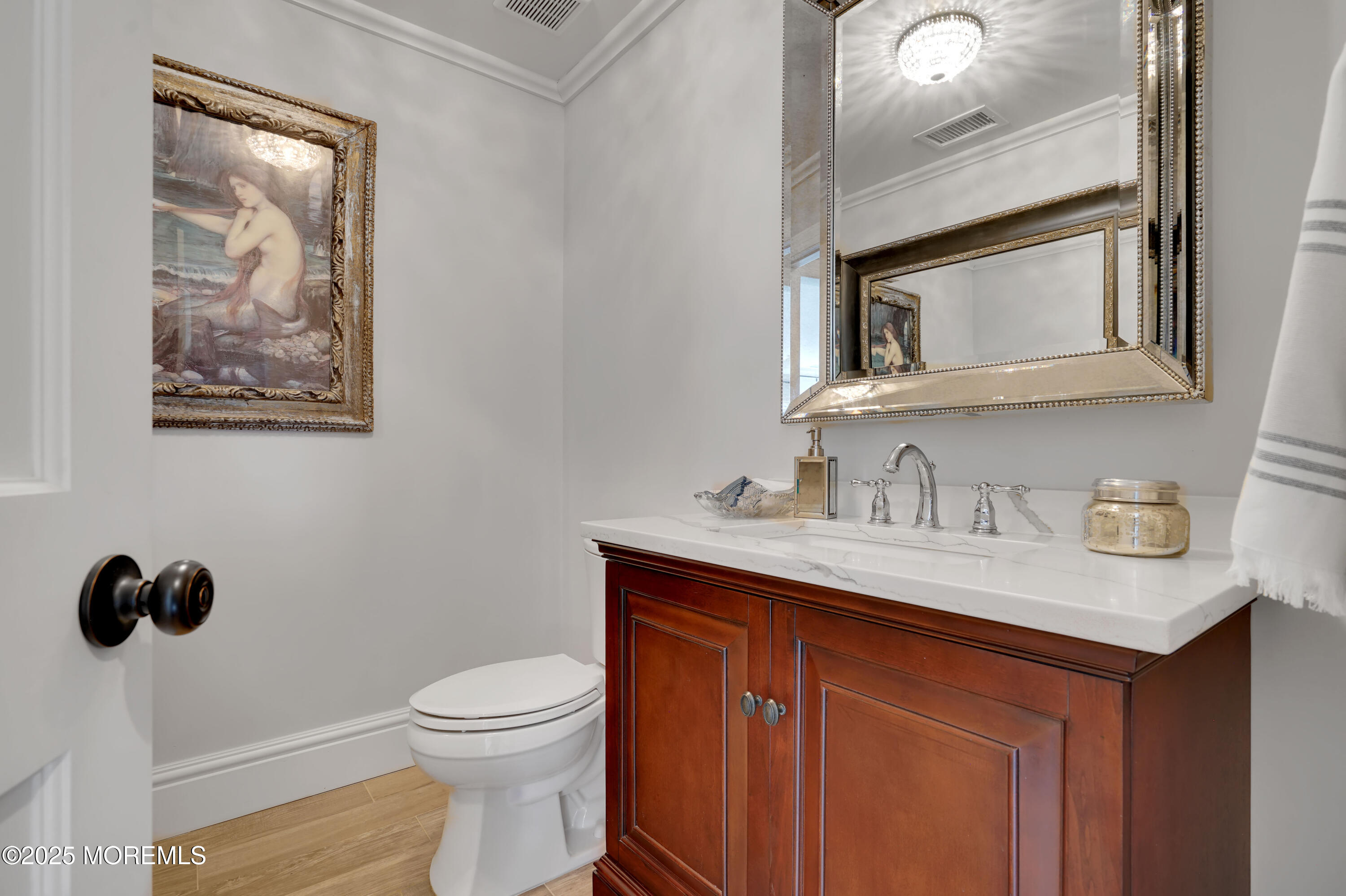 229 1st Avenue Manasquan, NJ 08736 - Photo 20 of 32 a bathroom with a toilet a sink and mirror