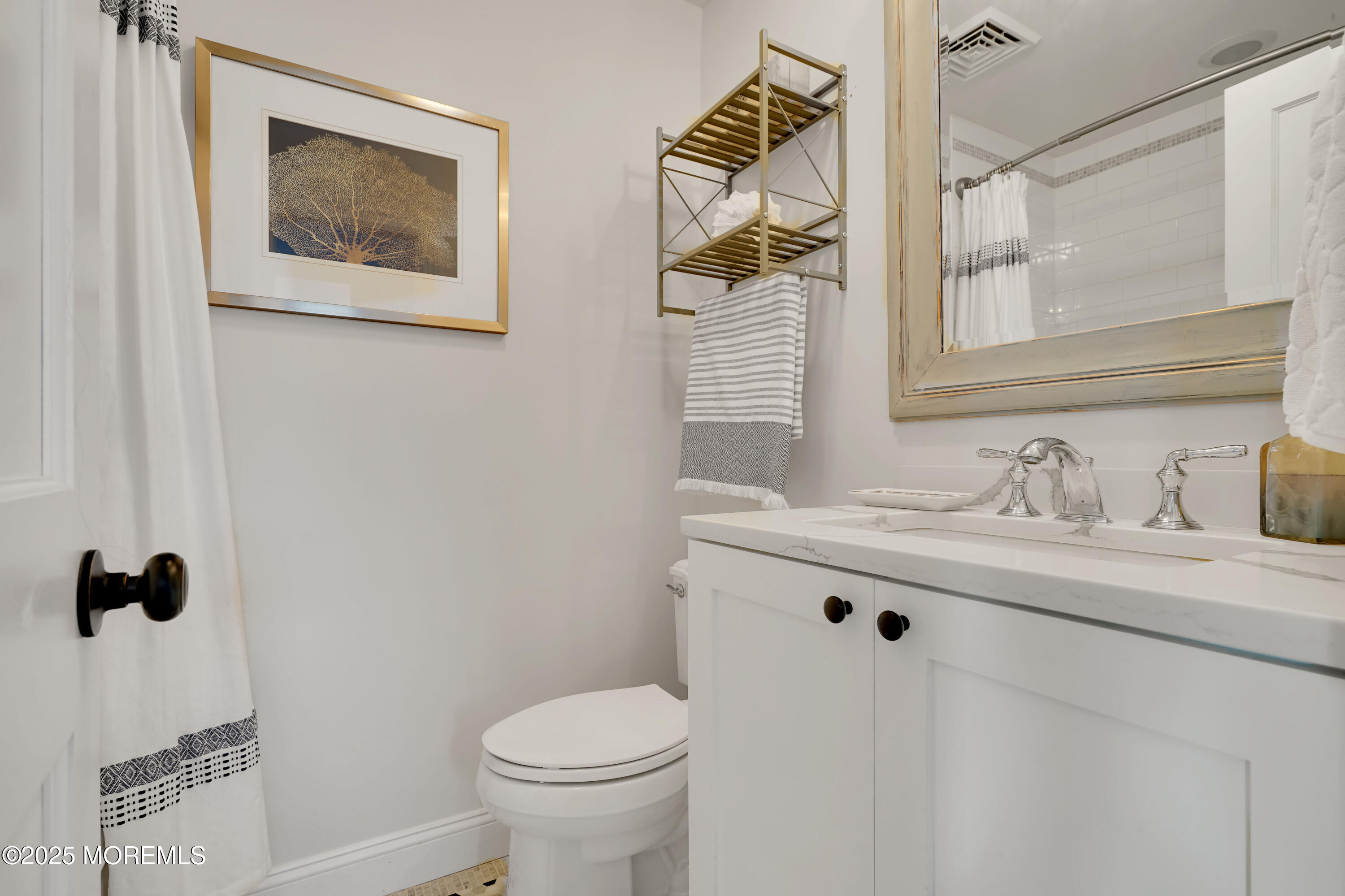 229 1st Avenue Manasquan, NJ 08736 - Photo 22 of 32 a bathroom with a granite countertop sink a toilet and a mirror