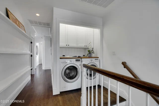 a view of a hallway with washer and dryer