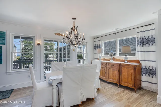 a living room with stainless steel appliances granite countertop furniture and wooden floor