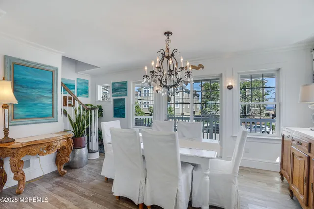 a view of a dining room with furniture wooden floor and chandelier
