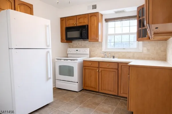 a utility room with sink dryer and washer