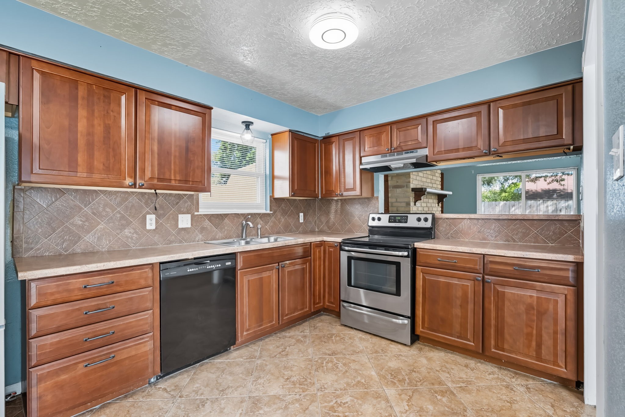 9731 Shell Rock Road La Porte, TX 77571 - Photo 13 of 25 a kitchen with stainless steel appliances granite countertop a stove sink and cabinets