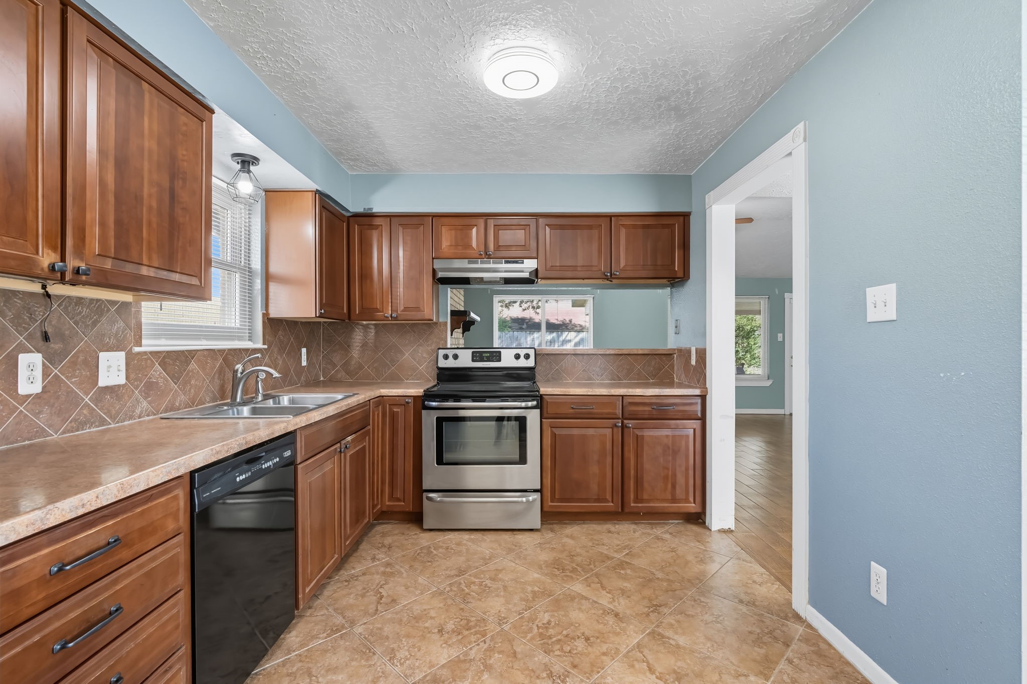 9731 Shell Rock Road La Porte, TX 77571 - Photo 14 of 25 a kitchen with a sink stove and cabinets