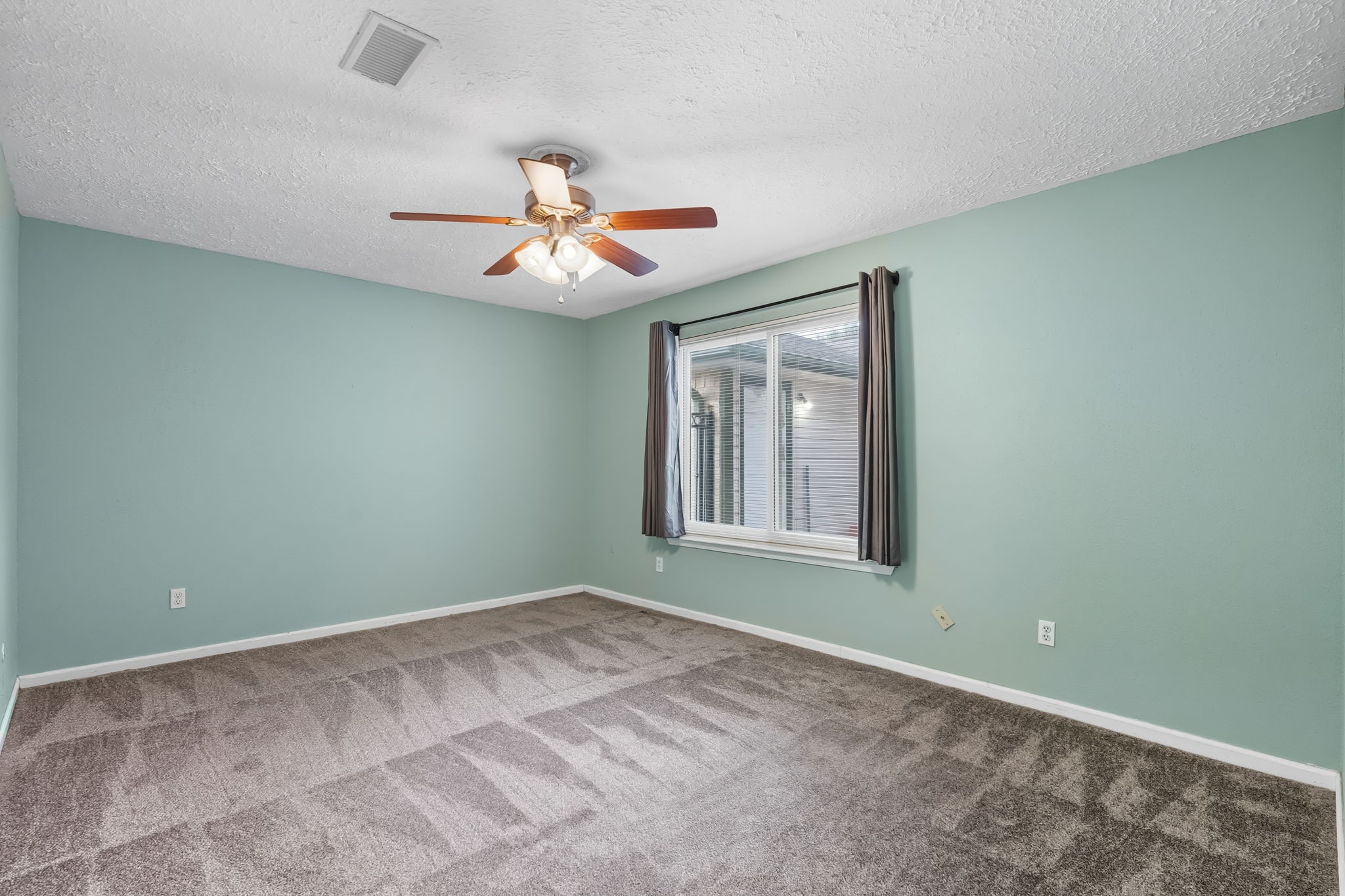 9731 Shell Rock Road La Porte, TX 77571 - Photo 15 of 25 an empty room with chandelier fan and windows
