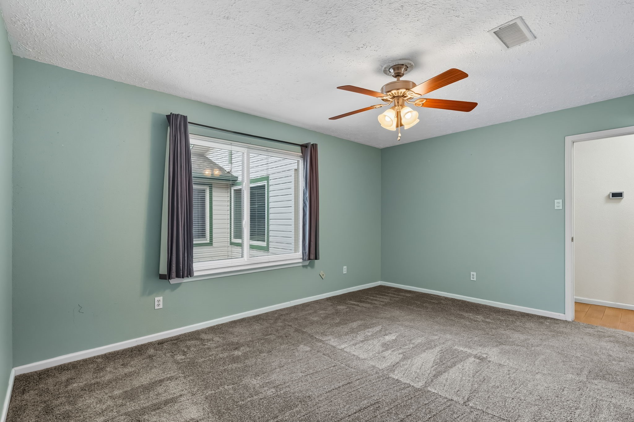 9731 Shell Rock Road La Porte, TX 77571 - Photo 17 of 25 an empty room with a window and a fan