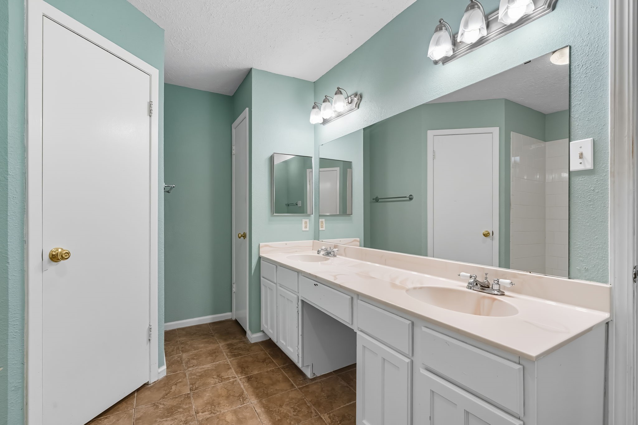 9731 Shell Rock Road La Porte, TX 77571 - Photo 19 of 25 a bathroom with a sink double vanity and a mirror