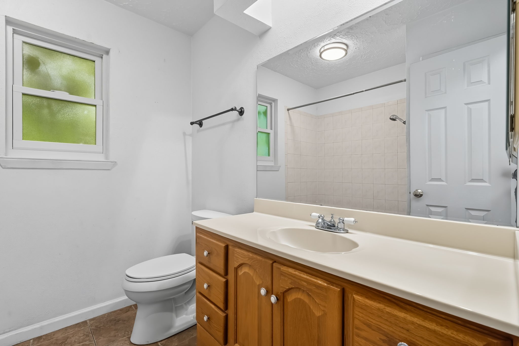 9731 Shell Rock Road La Porte, TX 77571 - Photo 21 of 25 a bathroom with a sink a toilet and a mirror