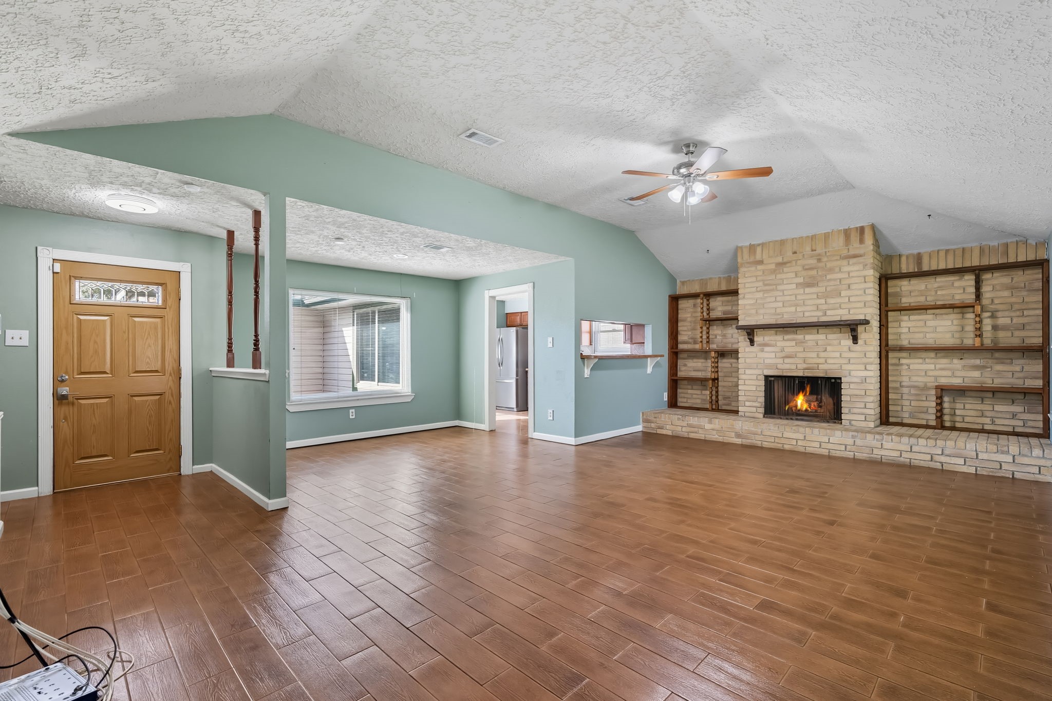 9731 Shell Rock Road La Porte, TX 77571 - Photo 4 of 25 wooden floor fireplace and windows in an empty room