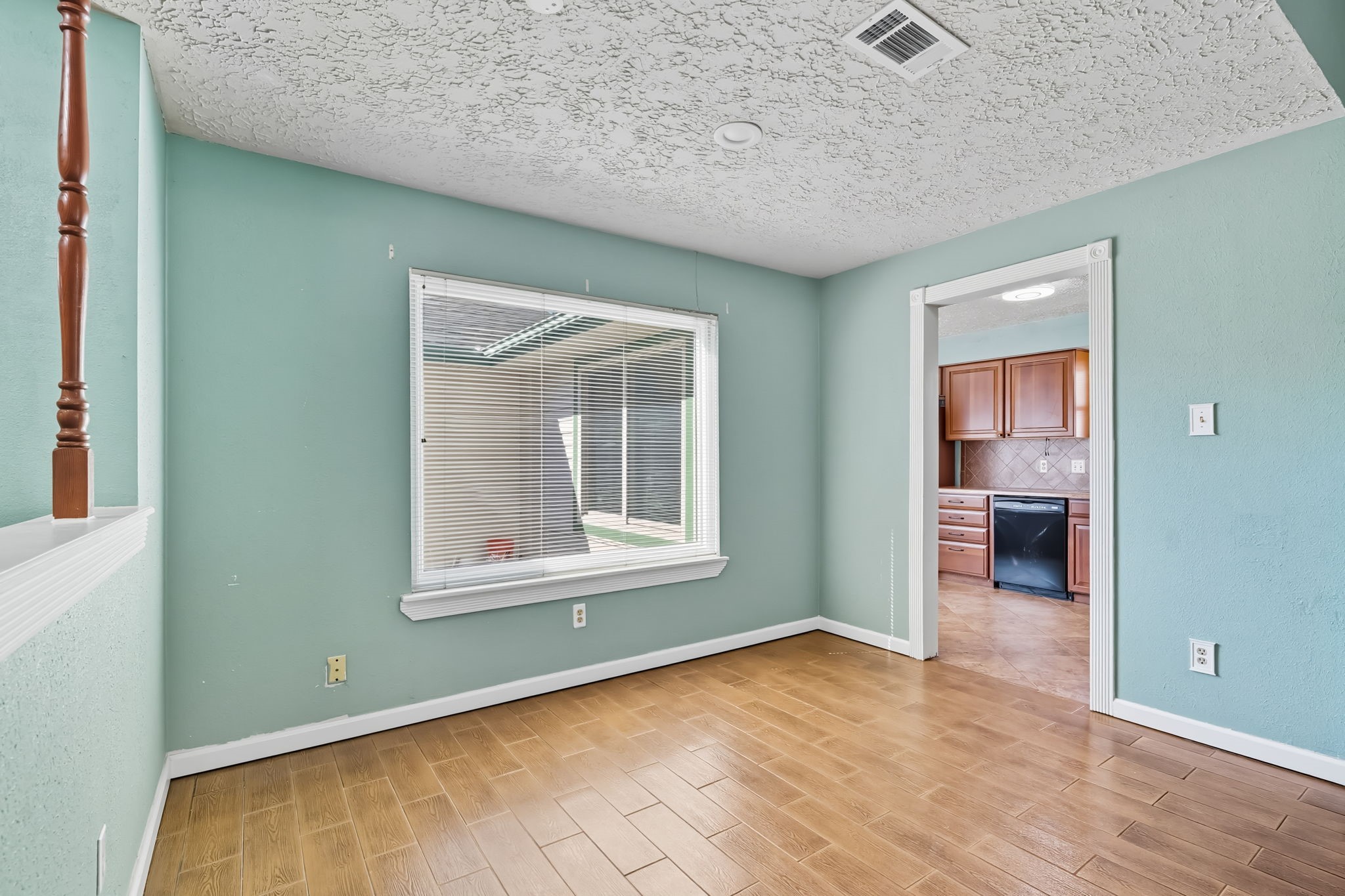 9731 Shell Rock Road La Porte, TX 77571 - Photo 8 of 25 an empty room with wooden floor and a window