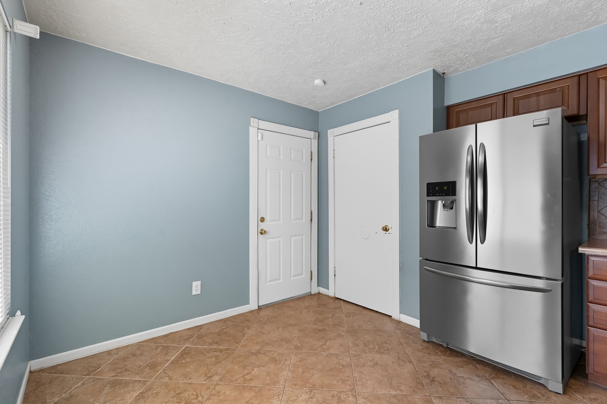 9731 Shell Rock Road La Porte, TX 77571 - Photo 10 of 25 a metallic refrigerator freezer sitting in a kitchen