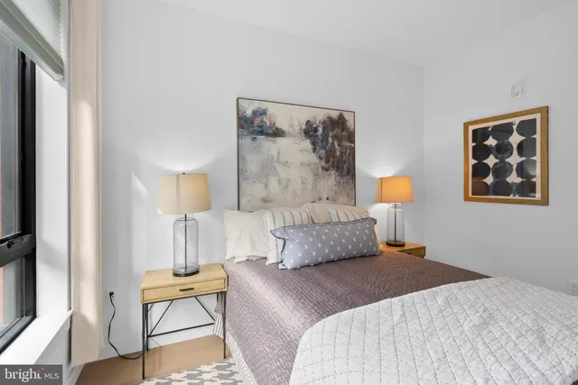 a bedroom with a bed and lamp on table