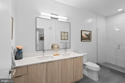 a bathroom with a sink a toilet and mirror