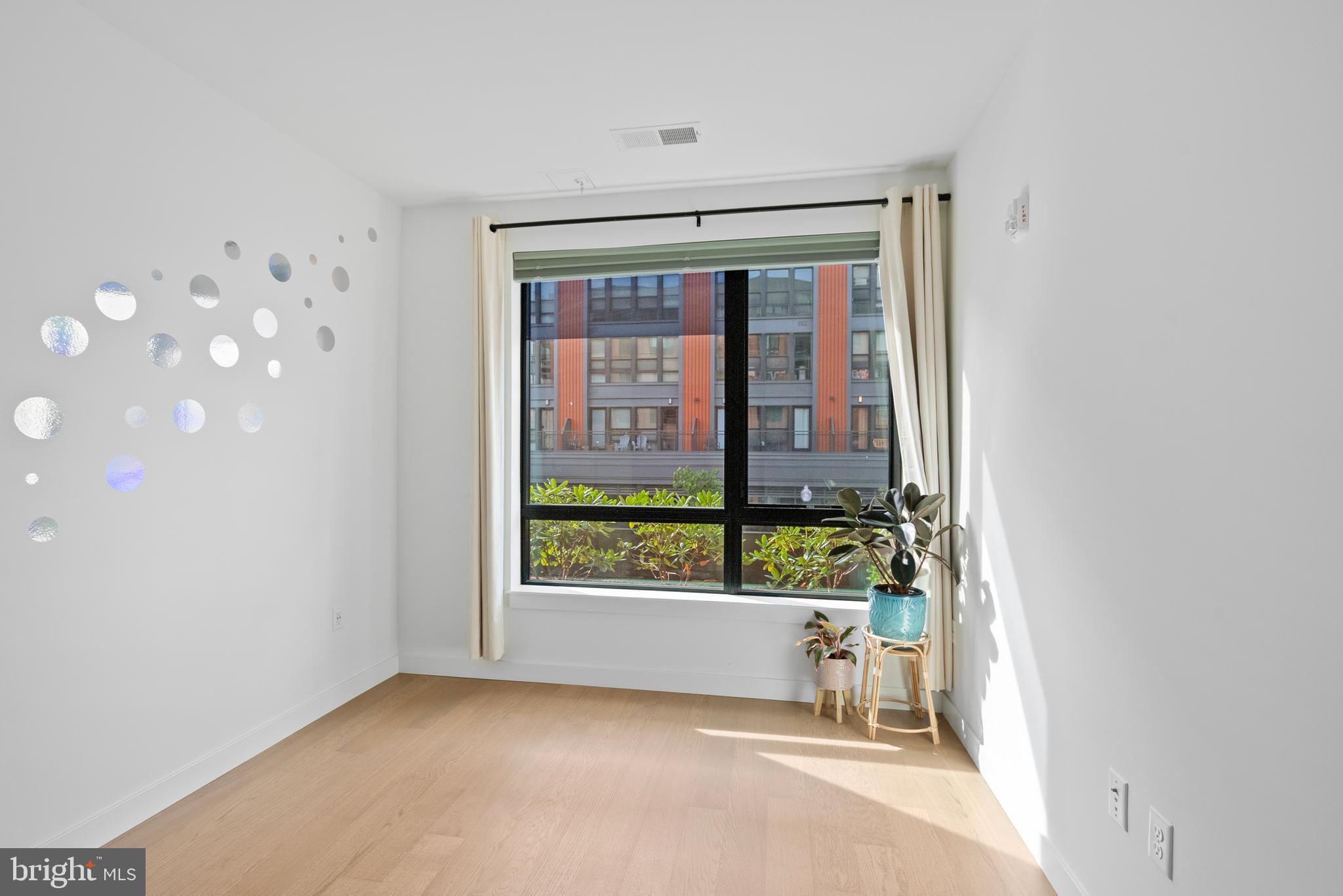 7175 12th Street Northwest, Unit 214 Washington, DC 20012 - Photo 23 of 49 a view of an empty room with a window