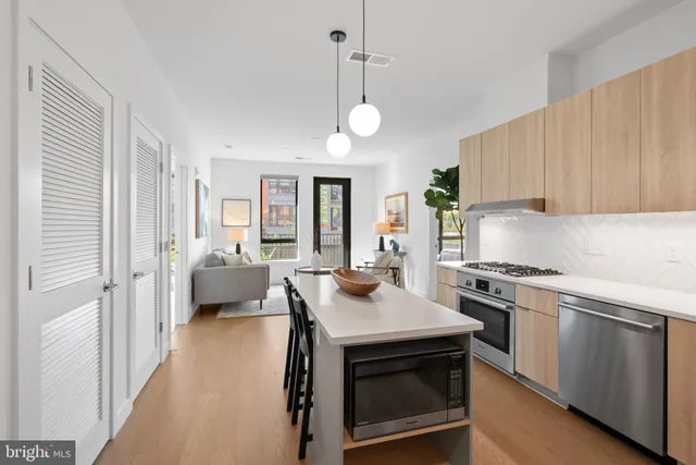 a kitchen with a stove a sink and a refrigerator