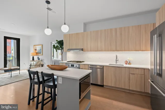 a kitchen with a table chairs stove and cabinets