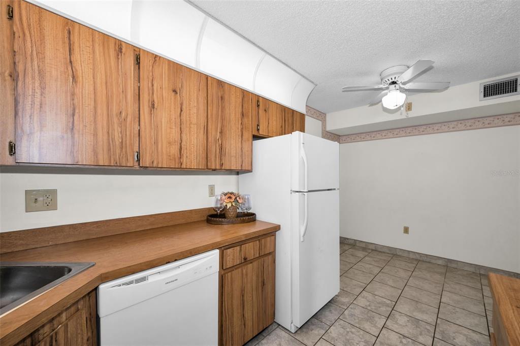 2687 Pine Ridge Way South, Unit B2 Palm Harbor, FL 34684 - Photo 12 of 68 a kitchen with a sink cabinets and appliances